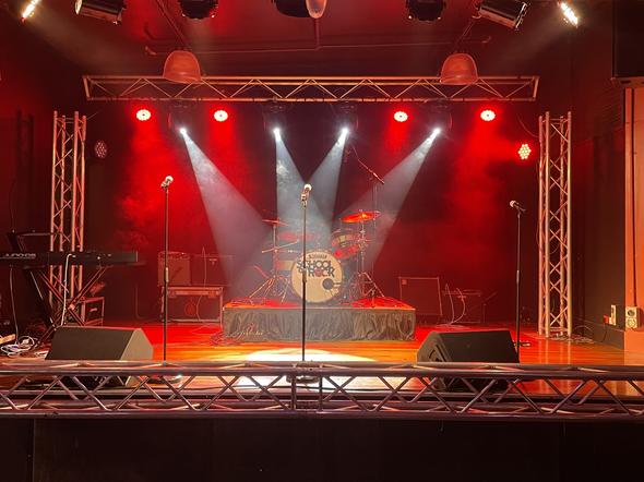 Synergy Productions stage with light show, drums and piano